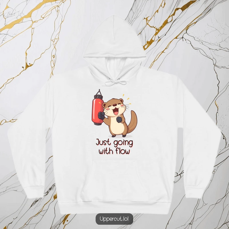 Funny otter wearing gloves, playfully punching a floating bag, a soft and humorous hoodie for cozy joy.